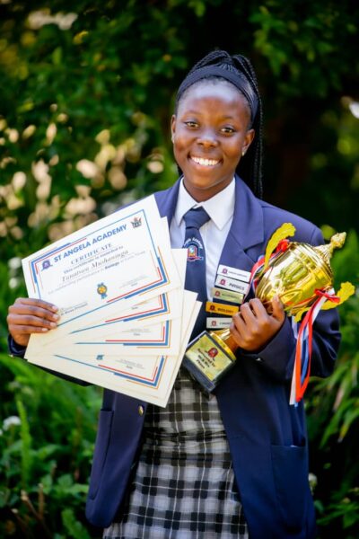 St. Angela High School holding Tropy and Certificates of Excellence in Sports